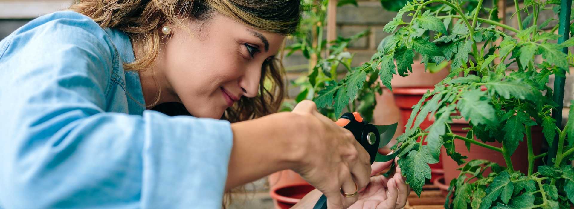 Portrait of woman gardener using pruning shear